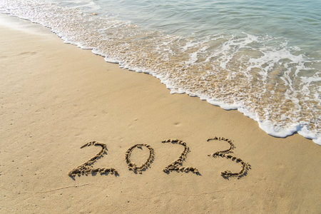 2023 handwritten in sand on a beautiful beach