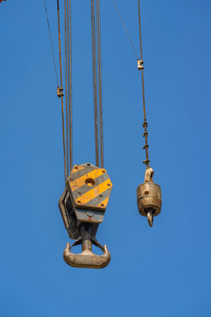crane steel hook with cable on blue sky, Industrial equipment or tools.の写真素材