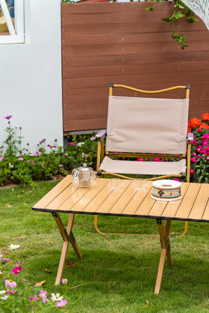 chair and glass tea pot on outdoor wooden tableの写真素材