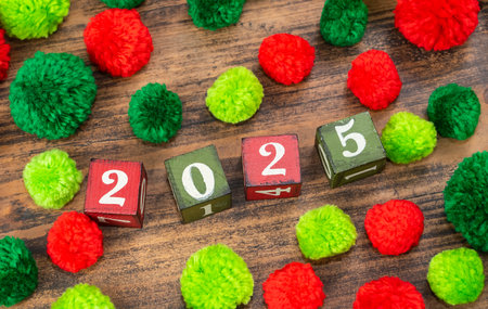 Red and green pompoms with wooden blocks 2025 on wood