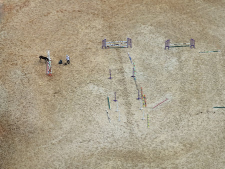 Top view of a man training a jumping horseの写真素材