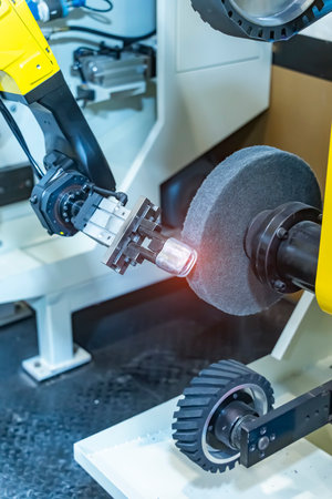 robotic arm handling the metal machined shaft parts polishing between the production line. automotive parts manufacturing process.の写真素材