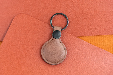 brown leather round Keychain on leather background