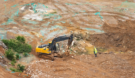 Excavator on earthmoving at construction site, aerial view.の写真素材