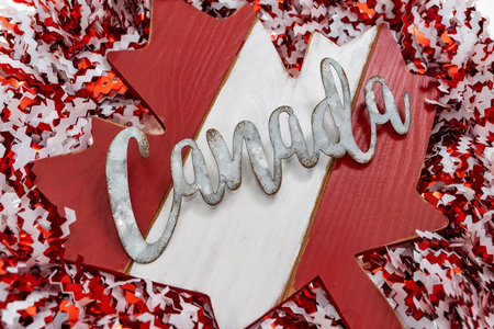 word canada with maple leaf on on wreath backgroundの写真素材