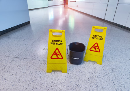 Yellow Caution wet floor sign on wet floorの写真素材