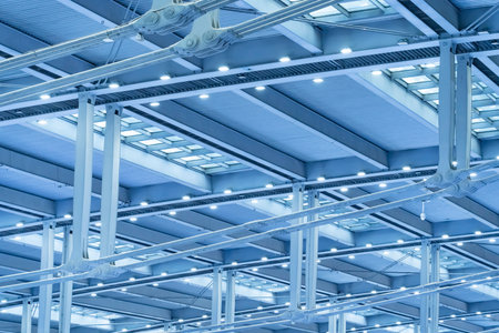 row of bright halogen spotlights on exhibition ceiling. industrial building interior