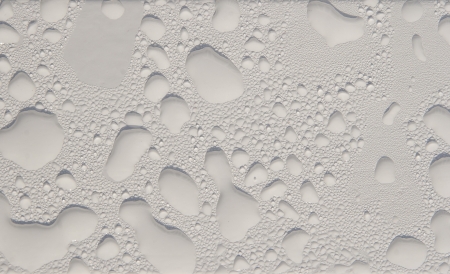 The drops of water on the white painted surfaceの写真素材