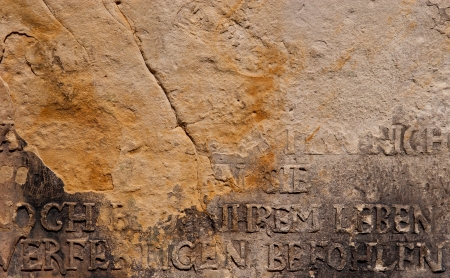 Ancient German inscription on broken stone wall of  church in Germanの写真素材