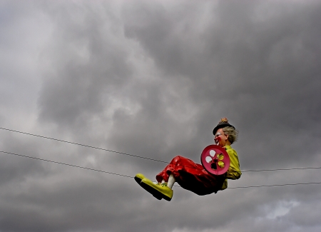 Clown dummy on the rope against the skyの写真素材
