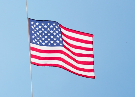 The American flag in the wind against the sky