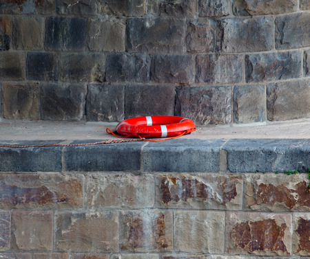 Lifebuoy under a stone bridgeの写真素材