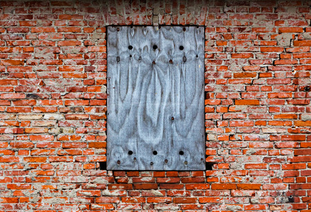 Bricked-up window on an old brick wall