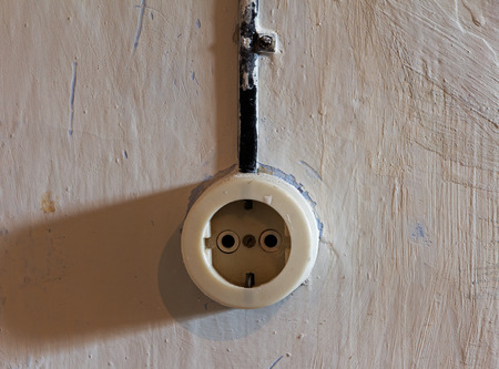 Old electrical outlet on decrepit wallの写真素材