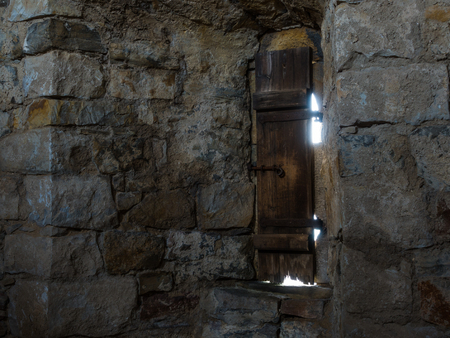 Dark room with stone walls and window