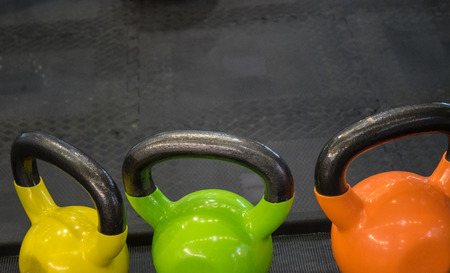 The multicolored  dumbbells  in a fitness center
