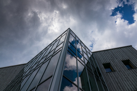 Reflection of the sky and clouds in the windows of a building .の写真素材