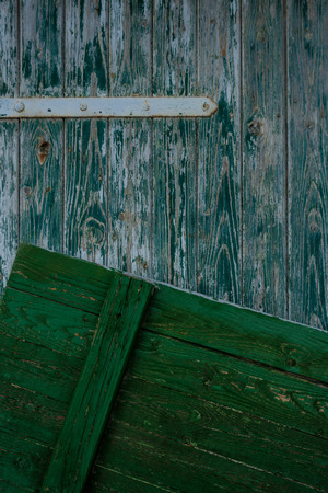 The old and wooden door at  gray wallの写真素材