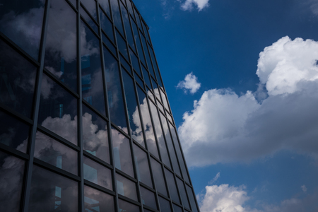 Reflection of the sky and clouds in the windows of a building .の写真素材