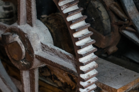 The pinion gear of an old mechanical device .
