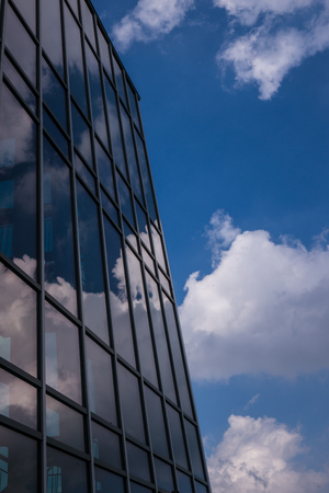 Reflection of the sky and clouds in the windows of a building .の写真素材