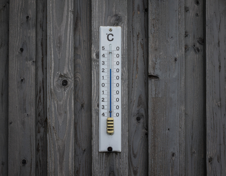 Mercury thermometer Celsius on the wood wall.