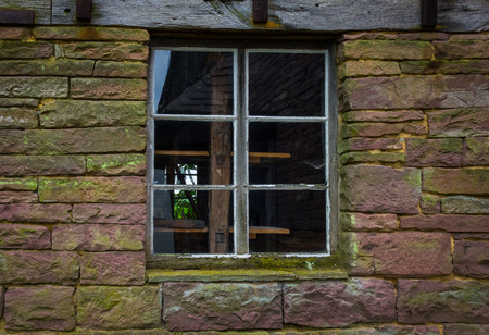 The wall and window of an old farmhouse.