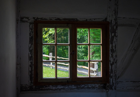 The wall and window of an old farmhouse inside .