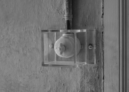 The old and ancient switch under glass.