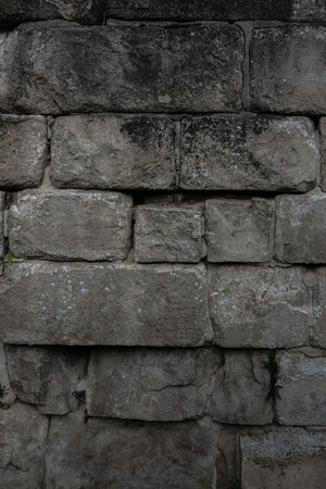 The old and ancient stone wall of a building.の写真素材