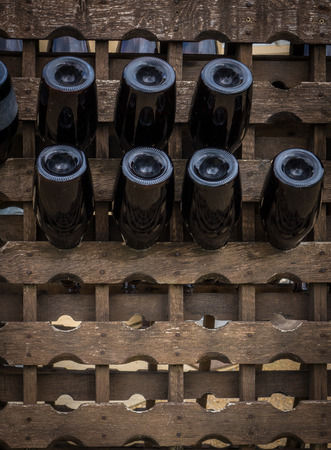 The wine bottles stored in a wood rack.の写真素材