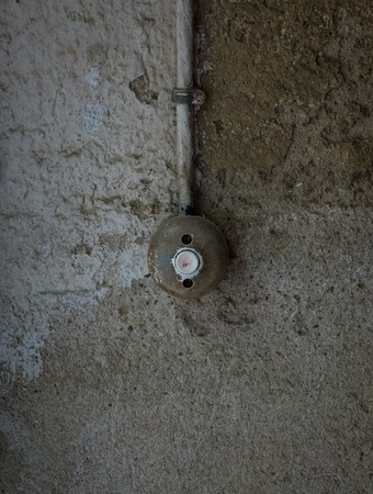 The old and ancient bell on a wall.の写真素材