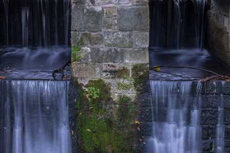The waterfall out dam of city pond in Bueckeburg, Germany.の写真素材