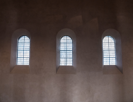 The old and ancient window in dark room .