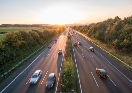 The road traffic on a motorway at sunset .の写真素材