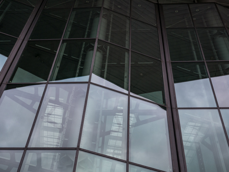 The glass architecture in city against a sky .の写真素材
