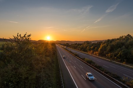 The road traffic on a motorway at sunset .の写真素材