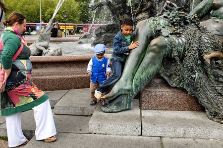 Kids playing near Neptune Fountain Neptunbrunnen in Berlin, Germany. May 2014 Details.のeditorial素材