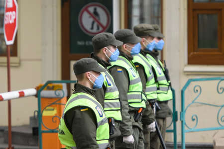 policemen stand guard at entrance of Kyiv Pechersk Lavra, where multiple cases of COVID19 confirmed....