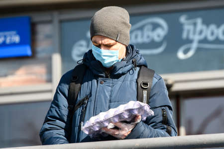 Man wearing protective mask as a preventive measure against the coronavirus COVID 19 on street in...