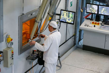 Worker operating in factory for treatment of hard radioactive waste at Chernobyl nuclear power...