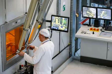 Worker operating in factory for treatment of hard radioactive waste at Chernobyl nuclear power...