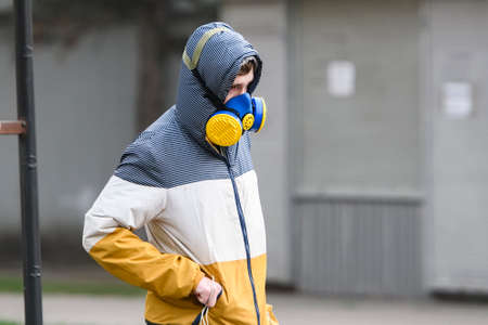 Man wearing protective respirator as a preventive measure against the coronavirus COVID 19 on street in Kyiv, Ukraine.のeditorial素材