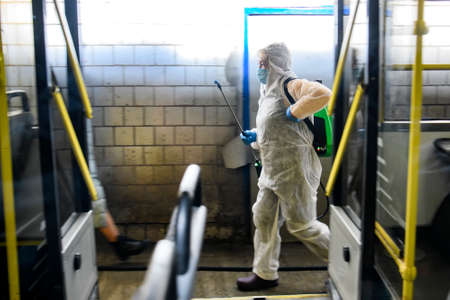 Employee of trolleybus park disinfects trolley cabin against the coronavirus COVID-19. Kyiv, Ukraineのeditorial素材