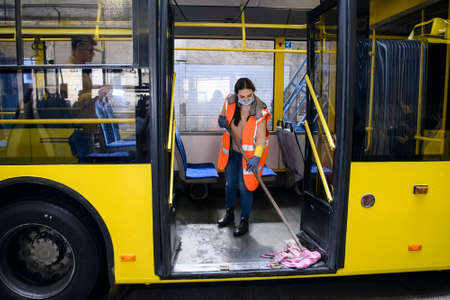 Employee of trolleybus park disinfects trolley cabin against the coronavirus COVID-19. Kyiv, Ukraine