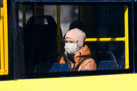 Public transport passenger wearing protective mask as a preventive measure against coronavirus COVID...