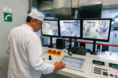 Worker operating in factory for treatment of hard radioactive waste at Chernobyl nuclear power...