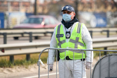 Police officer standing at a checkpoint during coronavirus disease COVID-19 outbreak in Kyiv, Ukraineのeditorial素材