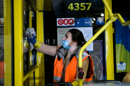Employee of trolleybus park disinfects trolley cabin against the coronavirus COVID-19. Kyiv, Ukraine