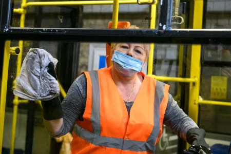 Employee of trolleybus park disinfects trolley cabin against the coronavirus COVID-19. Kyiv, Ukraineのeditorial素材